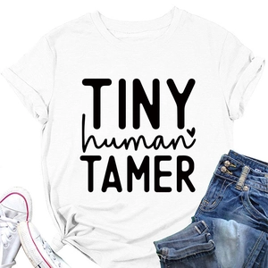 Flat lay of white cotton T-shirt with black Tiny Human Tamer text and heart icon