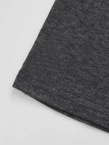 Macro detail of the double-needle stitched hem on dark grey knit V-neck T-shirt