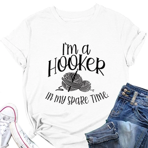 Flat lay of white cotton T-shirt with I'M A HOOKER print, jeans and canvas shoes
