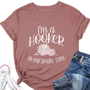 Flat lay of dusty pink T-shirt with hooker knitting print, denim jeans and sneakers