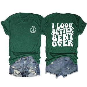 Flat lay of a green crew neck T-shirt with white back print and distressed denim shorts