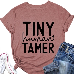 Detail of Tiny Human Tamer text on pink cotton t-shirt styled with jeans and sneakers