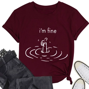 Close-up of wine red t-shirt with i'm fine text, rolled sleeves and knotted hem detail