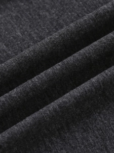 Close-up of soft charcoal grey knitted fabric texture showing fine weave and soft drape