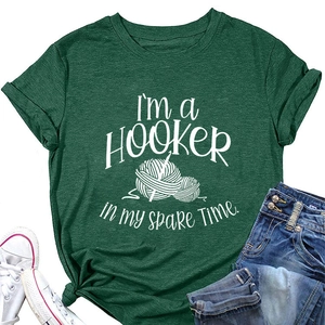 Detail of dark green t-shirt with I'm a Hooker crochet print and knit texture