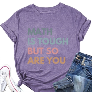 Flat lay of purple cotton t-shirt featuring colorful Math Is Tough printed slogan