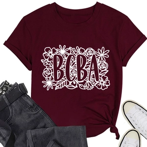 Close-up of burgundy cotton T-shirt featuring white BCBA text and floral print details