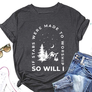 Close-up of charcoal grey t-shirt featuring a mountain star graphic and white sneakers