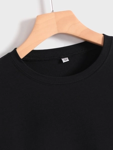 Detail of the crew neck collar and double-stitch sewing on this black cotton mom t-shirt