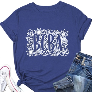Flat lay of navy blue T-shirt with BCBA floral print paired with jeans and sneakers