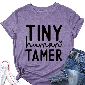 Detail of purple cotton T-shirt featuring TINY human TAMER print with soft textured fabric
