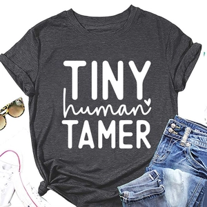 Flat lay of dark grey T-shirt with TINY human TAMER print and denim shorts