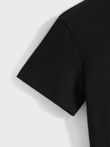 Detail of double-needle stitching on the shoulder and sleeve of a black cotton t-shirt