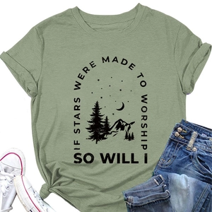 Detail of sage green T-shirt featuring starry night graphics and mountain illustration