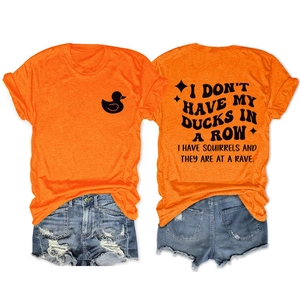 Flat lay of an orange crewneck T-shirt with black duck logo and artistic back slogan