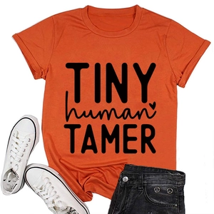 Close-up of bright orange crewneck T-shirt with black Tiny Human Tamer graphic print