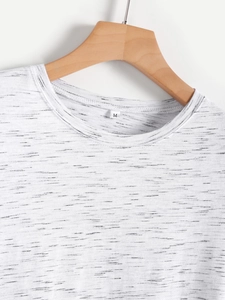 Close-up of the M-size crew neck detail on a white and black speckled knit T-shirt