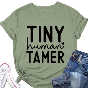 Close-up of bean green T-shirt with black Tiny Human Tamer print and heart graphic