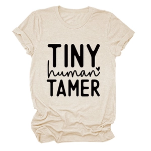 Detail of rolled sleeve and Tiny Human Tamer print on beige cotton t-shirt