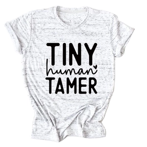 Detailed close-up of Tiny Human Tamer slogan printed on heather white cotton t-shirt