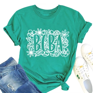 Detail of teal BCBA floral graphic t-shirt styled with denim jeans and sneakers