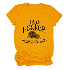 Detail of soft mustard cotton T-shirt featuring creative crochet hook and yarn illustration
