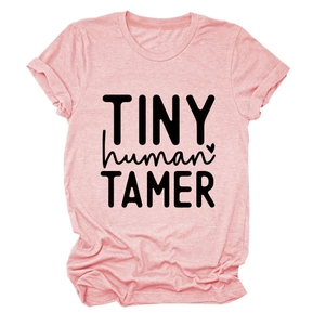 Flat lay of heather pink T-shirt featuring TINY human TAMER text and heart graphic