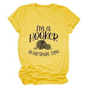 Detail of yellow cotton T-shirt featuring I'M A HOOKER crochet graphic and slogan