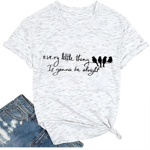 Flat lay of a heather white tee with bird silhouettes and motivational text and shorts