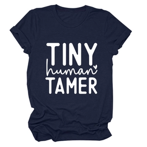 Detail of white TINY human TAMER print on a navy blue cotton crew neck t-shirt