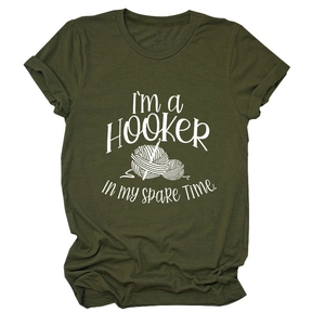 Detail of olive green t-shirt with I'm a Hooker crochet pun and yarn graphic