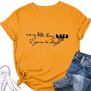 Bright yellow T-shirt with bird silhouettes and slogan styled with jeans and sneakers