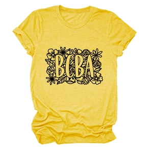 Detail showing BCBA floral print on a mustard yellow crew neck short sleeve cotton T-shirt