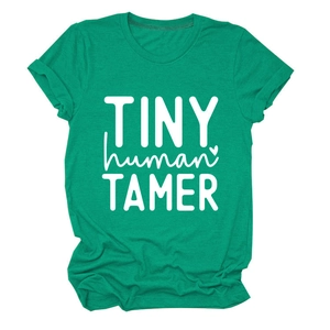 Close-up of green cotton T-shirt with white TINY human TAMER text on white background
