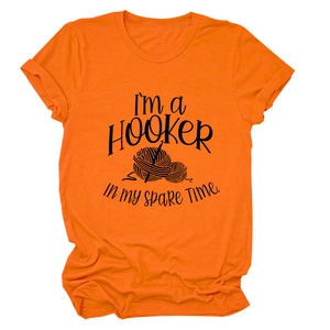 Detail of orange cotton T-shirt with black I'm a Hooker text and crochet ball design