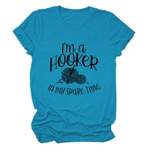 Close-up of printed graphic on teal heather t-shirt featuring crochet hook and yarn