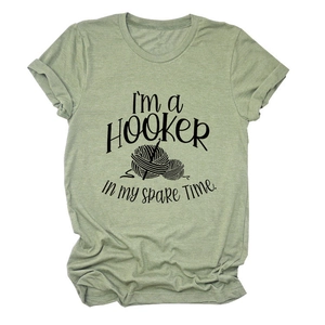 Close-up of heather green cotton T-shirt featuring 'I'M a Hooker' crochet print