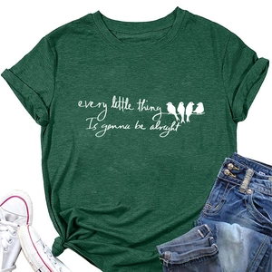 Flat lay of green t-shirt featuring bird graphics and every little thing is gonna be alright quote