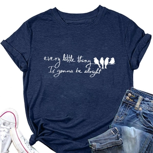 Flat lay of navy cotton T-shirt with birds print styled with jeans and white sneakers