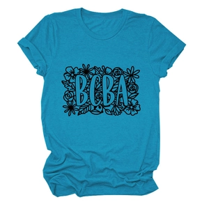 Detail of bright blue round neck t-shirt featuring BCBA lettering and floral print