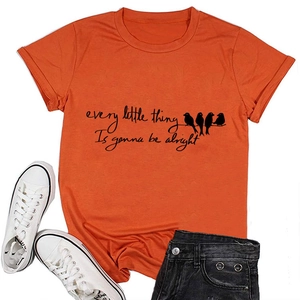 Flat lay of an orange cotton T-shirt featuring Every Little Thing bird print with accessories