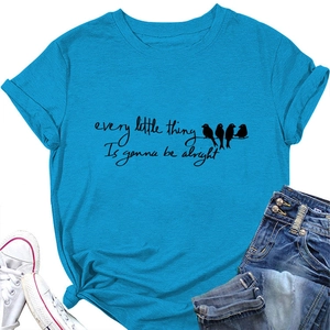 Flat lay of bright blue T-shirt with birds and quote print, jeans and canvas shoes