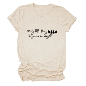 Detail of bird silhouettes and calligraphy print on beige cotton t-shirt fabric