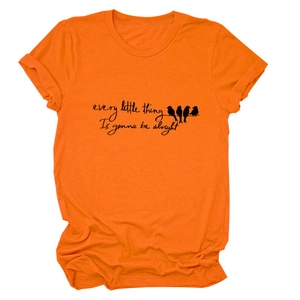 Close-up of bird silhouette print and text on bright orange short sleeve T-shirt