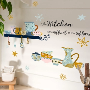 Detail of bohemian kitchen wall stickers with teapot and heart of the home quote