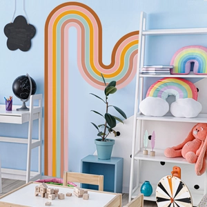 Detail of bohemian rainbow wall decals in earthy tones for nursery decor
