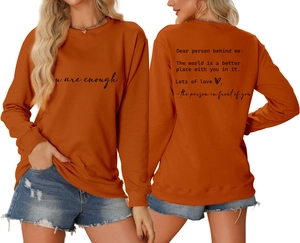 Front and back detail of orange crewneck sweatshirt with 'you are enough' print