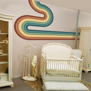 Detailed retro rainbow wall sticker with five curved stripes in a cozy nursery setting
