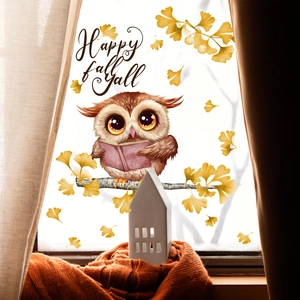 Close-up of owl and ginkgo leaf window sticker with Happy fall y'all text for autumn decor