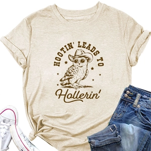 Flat lay of beige owl print T-shirt with cowboy hat graphics and casual denim jeans